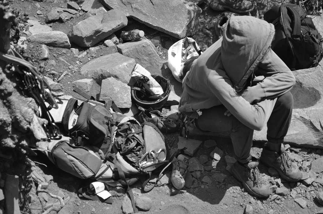 black and white po of man kneeling down next to sports equipment