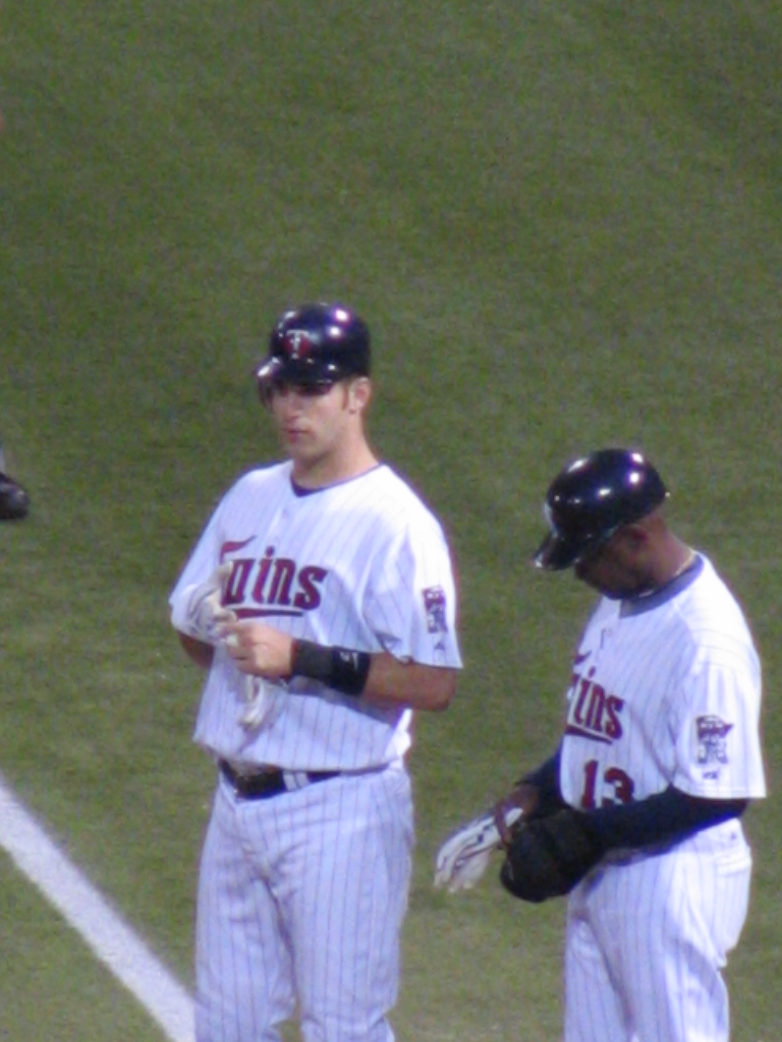 a baseball player in uniform talking with another player