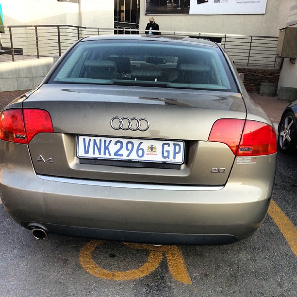 the back of an audi car parked in front of a building