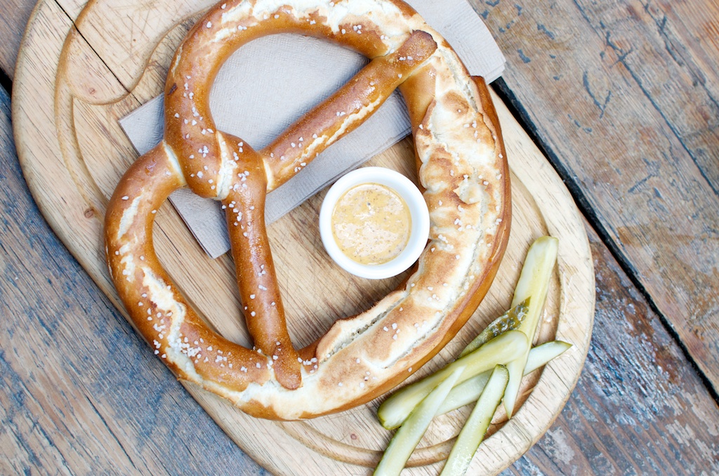 the pretzels and sauce on the plate are shaped like a smiley face