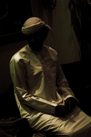 a person is sitting with a white outfit on