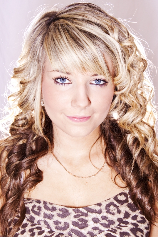 a blonde girl with blue eyes wearing a leopard print top