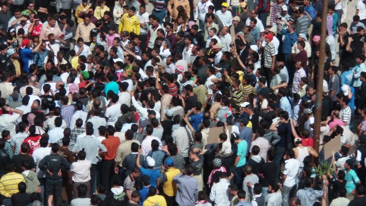 a large crowd of people standing around each other