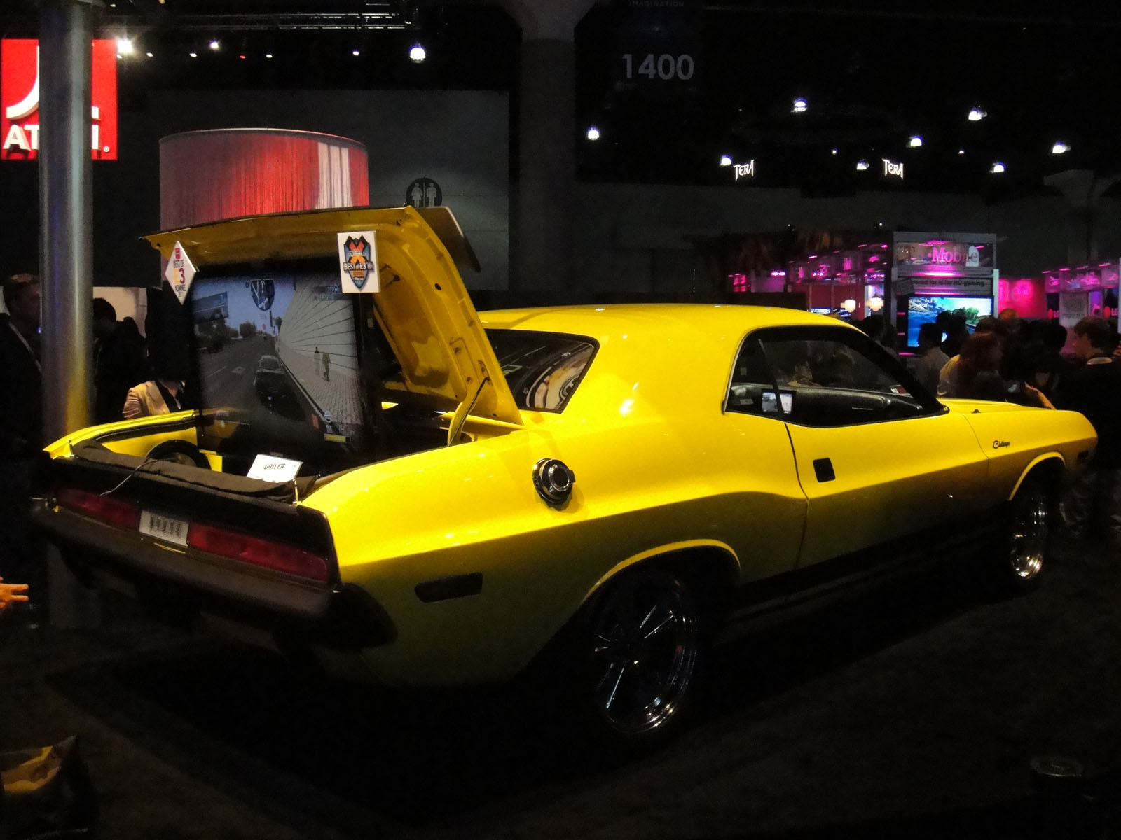 a yellow car with a hood opened on display