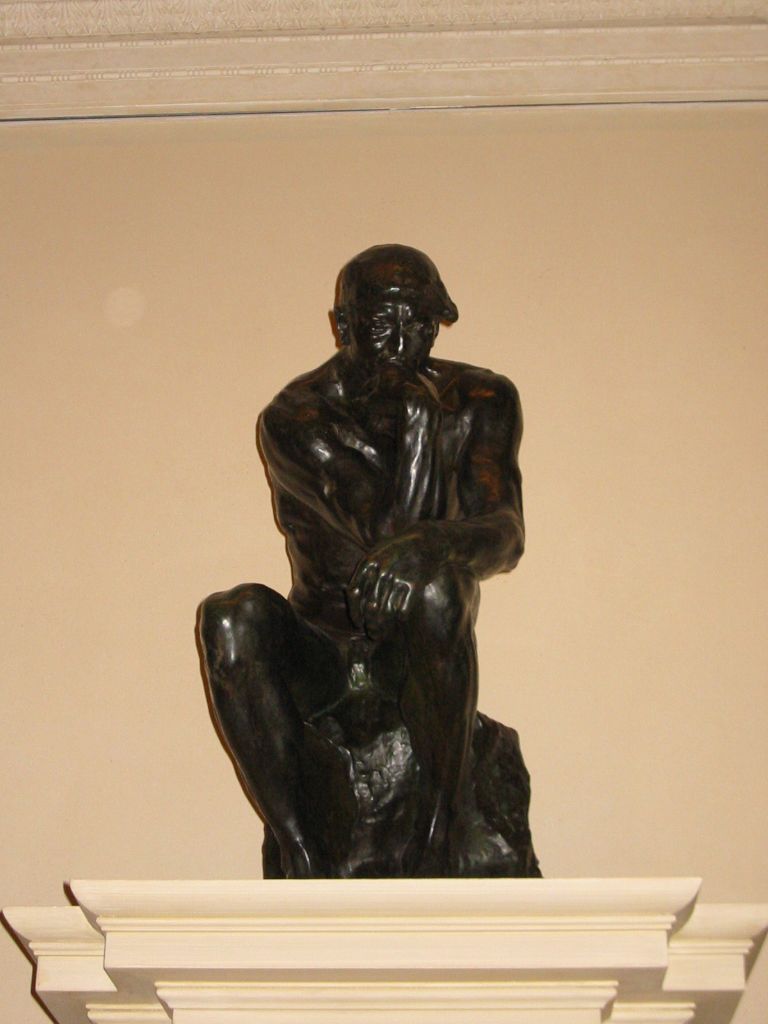 a bronze statue of two people emcing each other