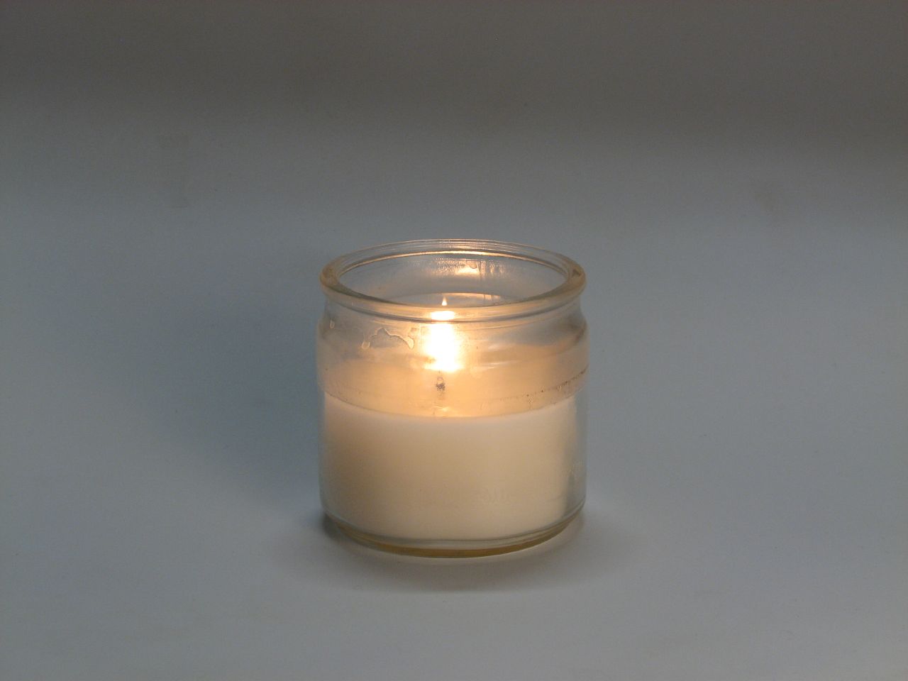 a white candle is lit and on the table