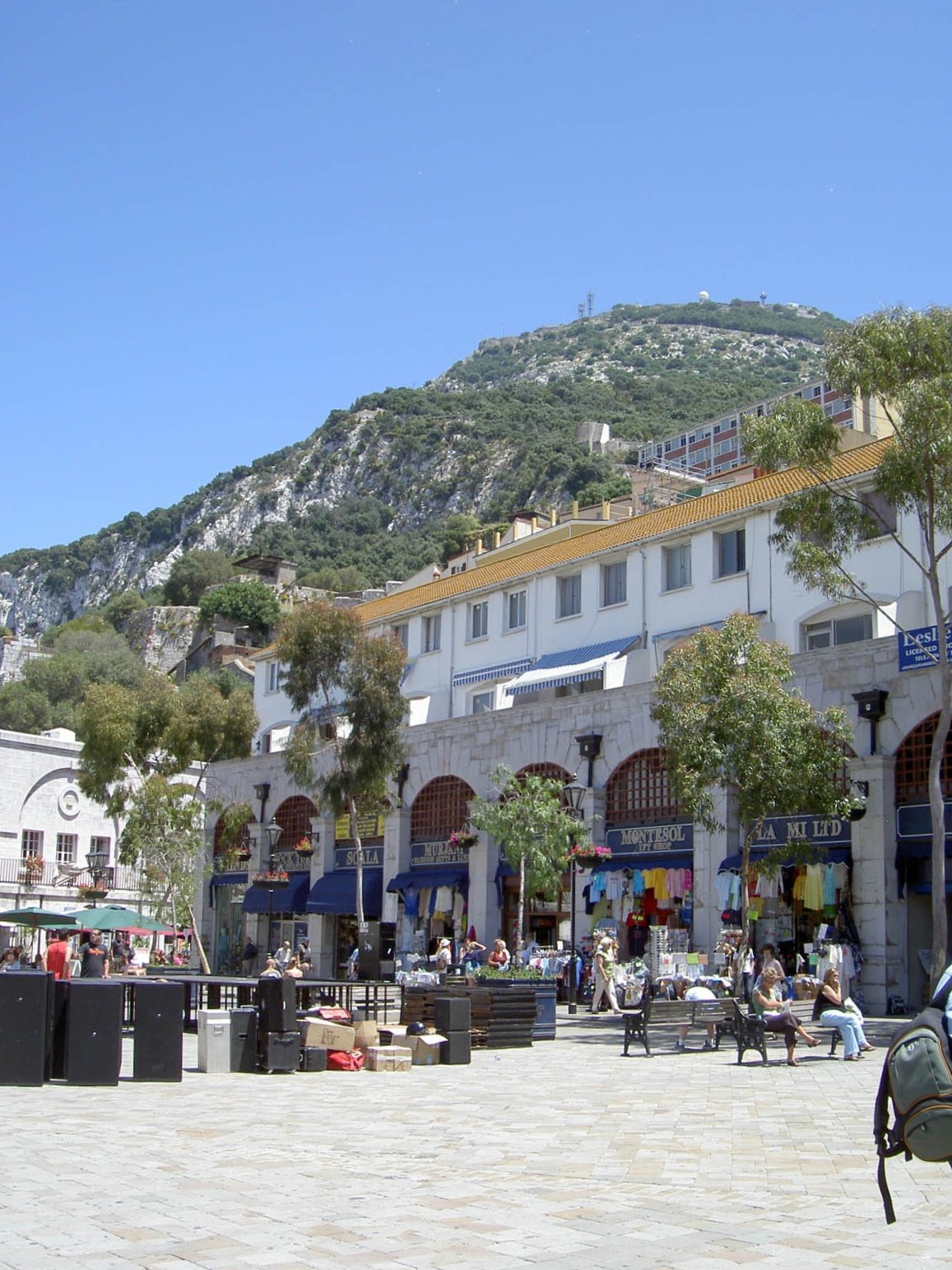 several people are walking through an old part of town