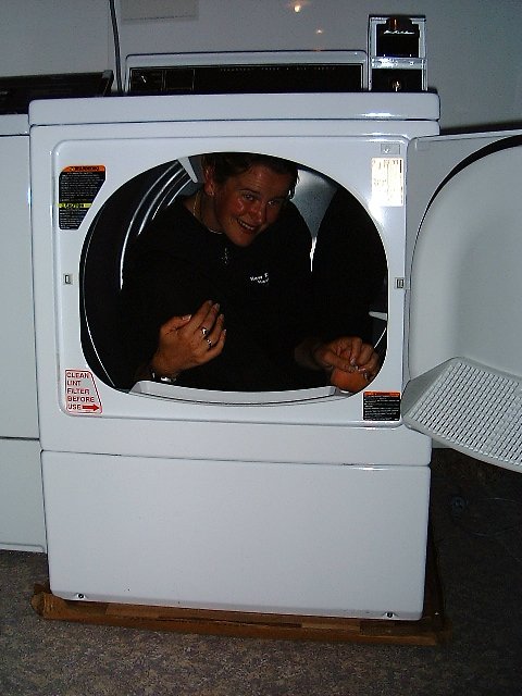 man in black shirt standing at the front of a dryer