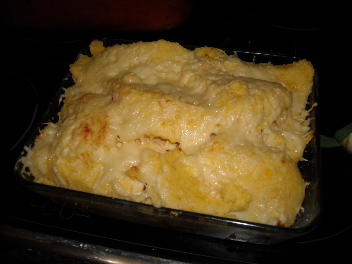 a casserole dish covered in cheese and meat