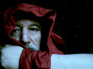 a person wearing a red cloak posing for the camera
