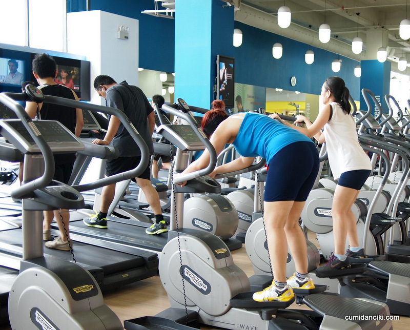 group of people exercising on exercise bikes in a gym