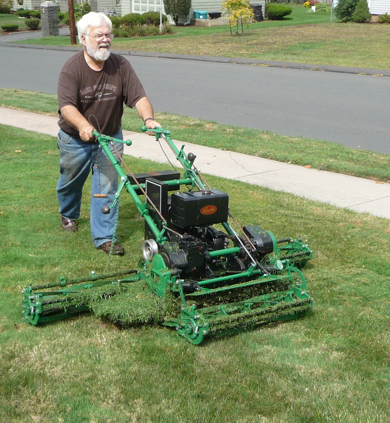 a man that is in the grass with a mower