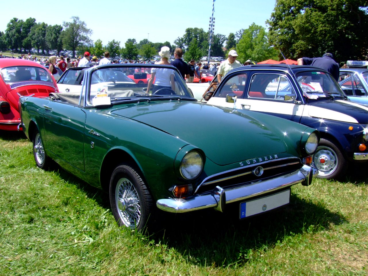 a number of different cars parked in the grass