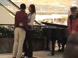 the young couple is standing near the piano