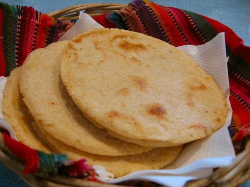 several tortillas in a basket on a table