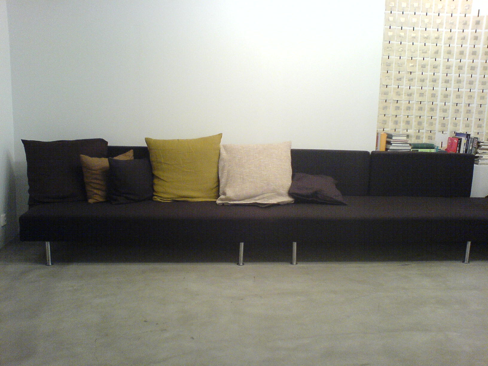a large couch has several different color pillows