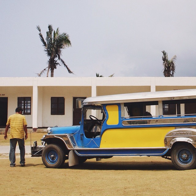 a vintage bus parked in front of a white building