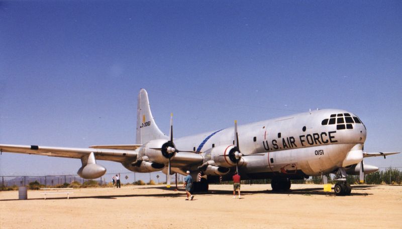 an air force airplane is parked on a dirt runway