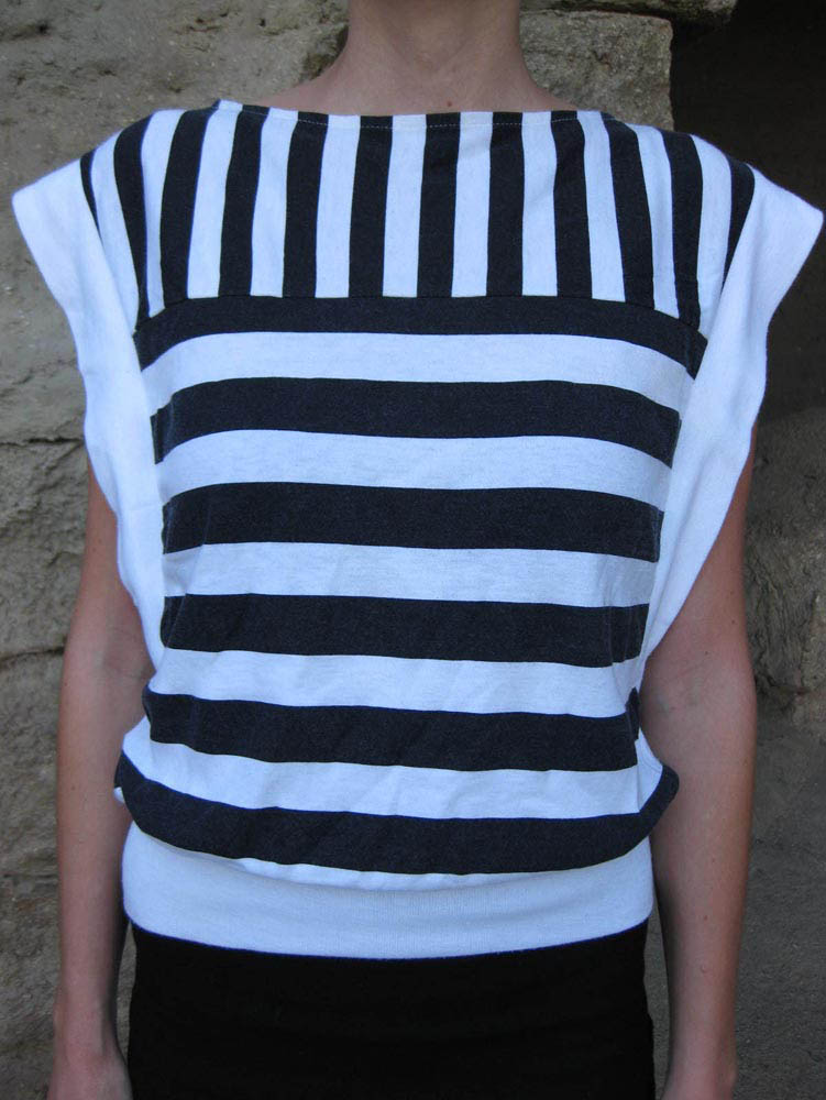 the top of a woman's striped top with a ruffled neck