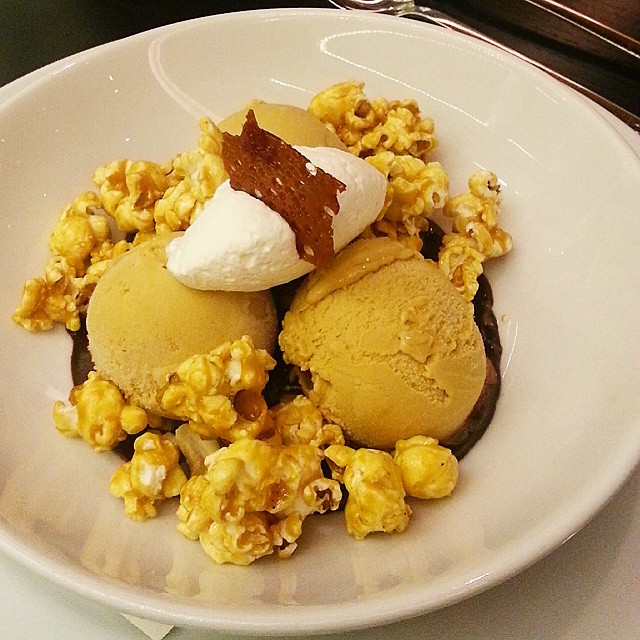 a plate with ice cream, walnuts and waffle ice cream