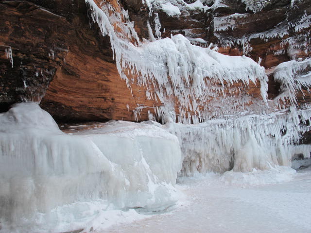 a view of frozen water falling down a rocky cliff