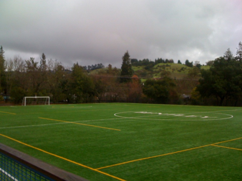 the soccer field is green and yellow, with blue stripes on it