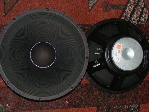 a stereo speaker on top of a tiled floor