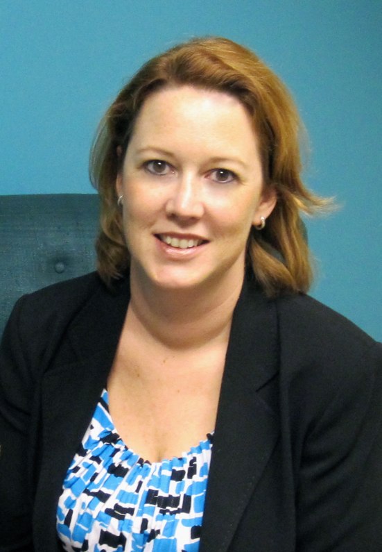 a woman with red hair is smiling at the camera