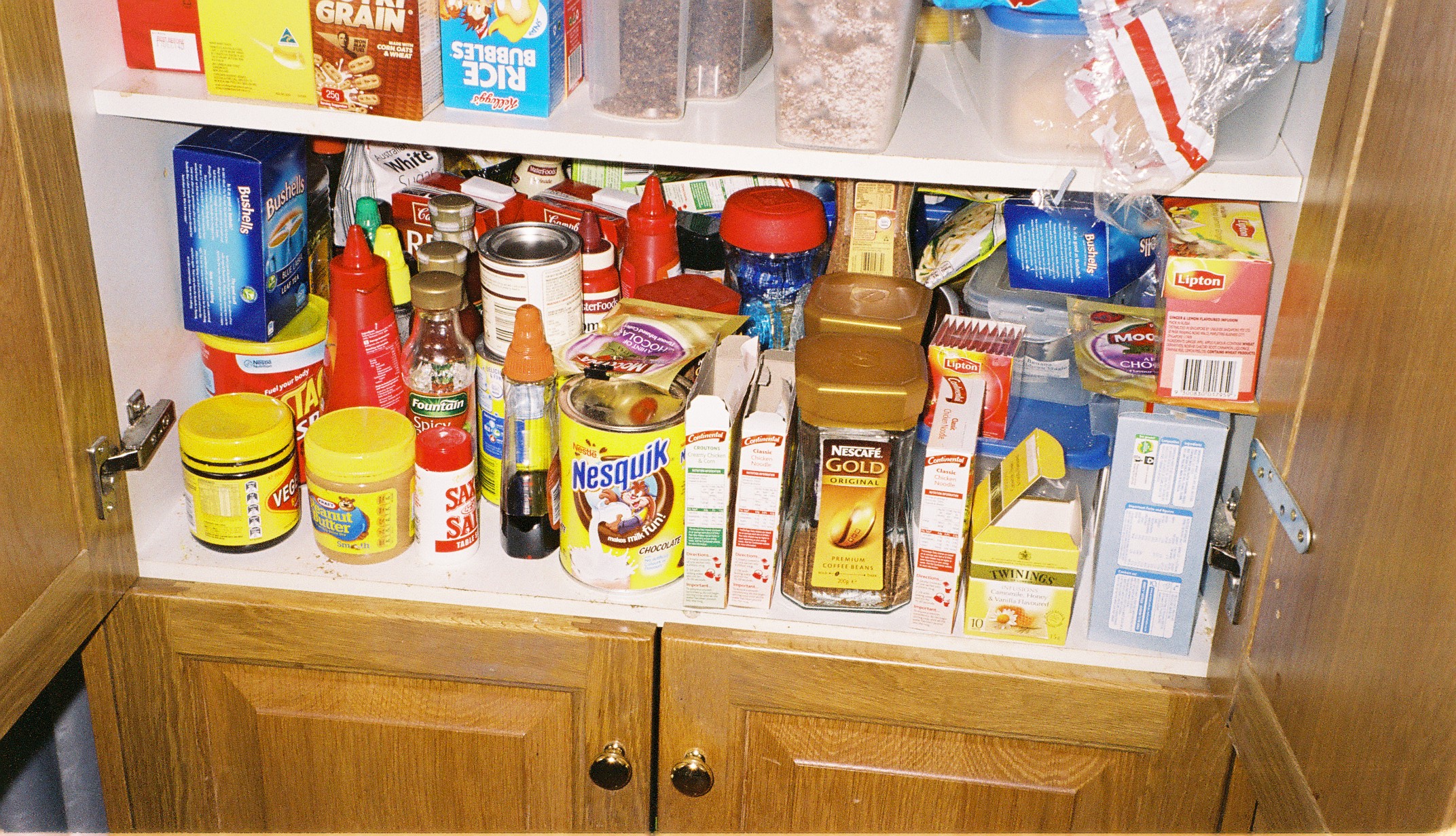 a bunch of food is stacked in the cupboard