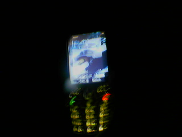 cellphone on a darkened night, with blurry image on screen