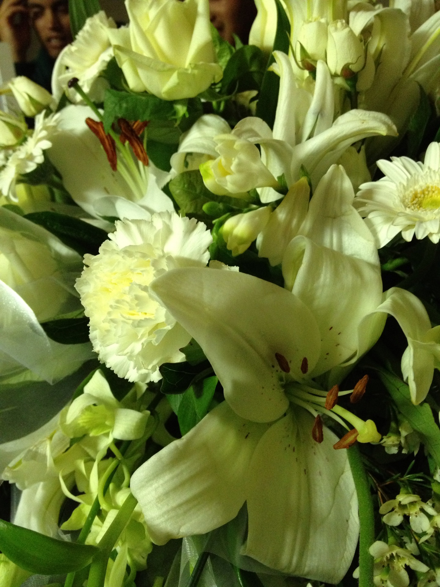 a bunch of white flowers and people in the background