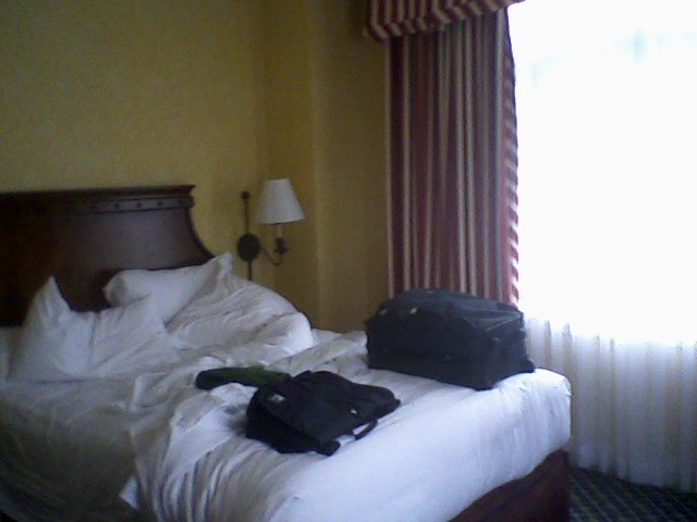 a suit case on the bed is ready for its guests