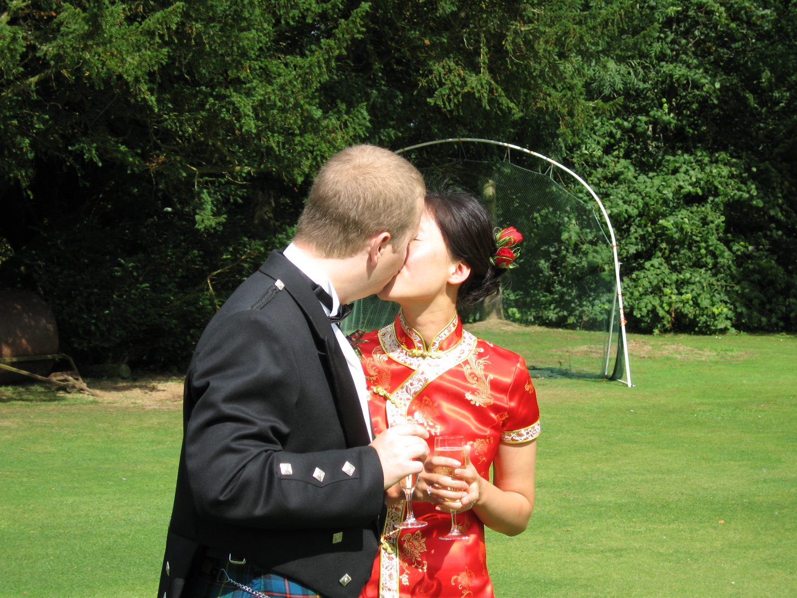 a couple in traditional clothing kissing each other