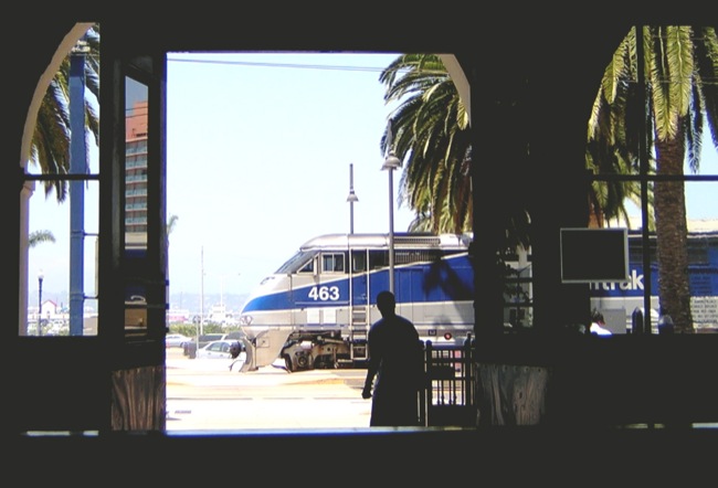 a man standing next to two large train doors