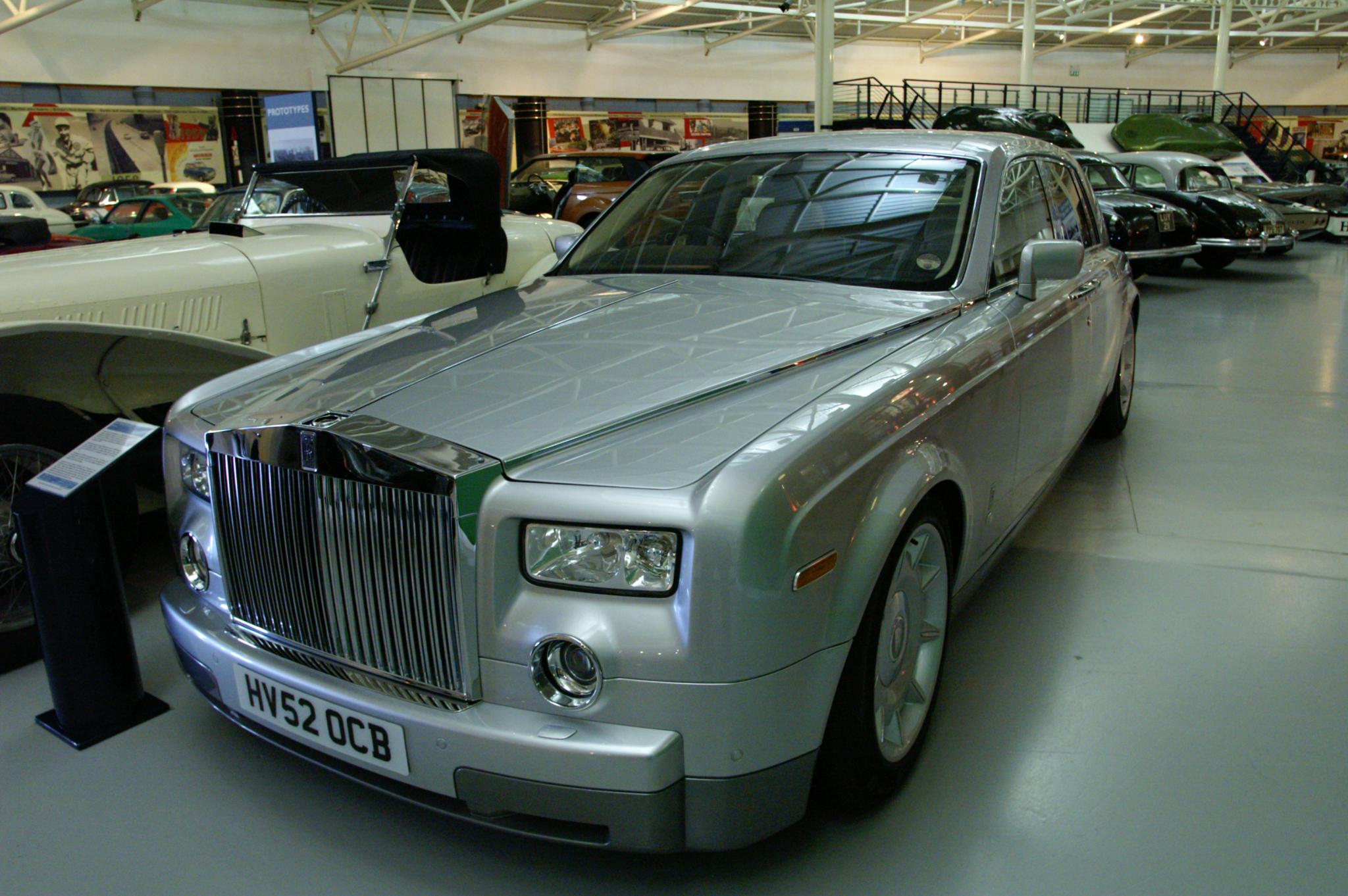 there is a large limo with chrome hoods in this showroom