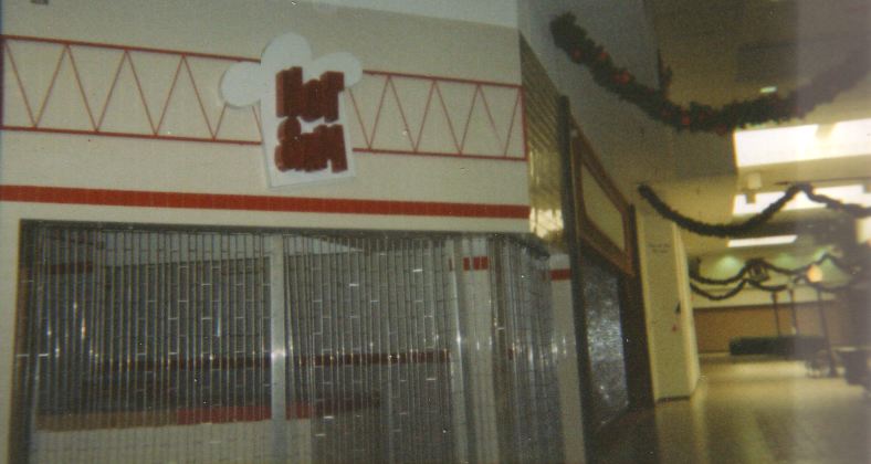 a storefront showing a door and sign