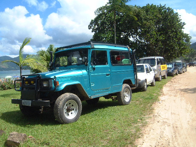 a group of vehicles parked on the side of a road