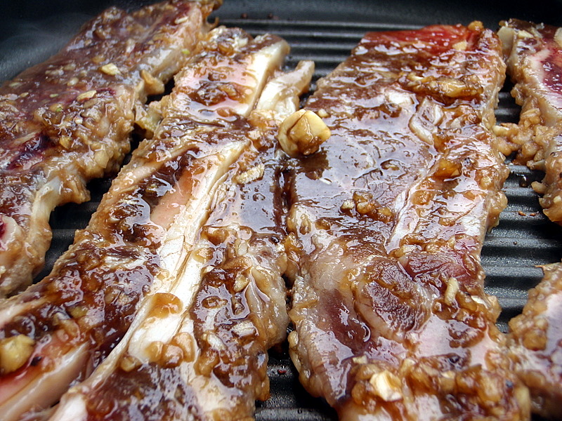 sliced meat is cooking on a grill as it looks to be browned