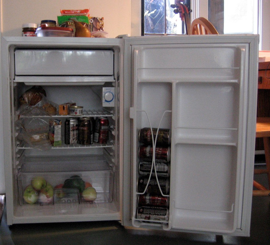 an open refrigerator with a variety of drinks inside