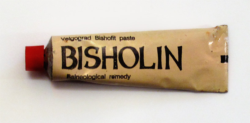 an old tube of biscolin on a white table