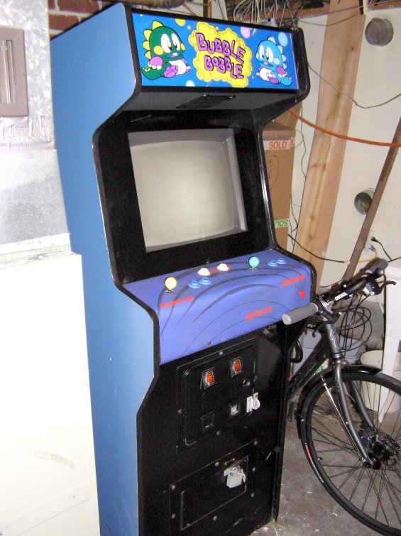 a man's bicycle stands next to a computer game