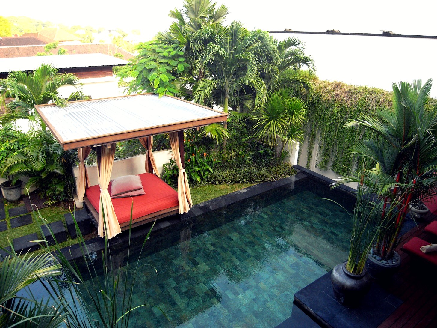 a house with a small pool and a red couch