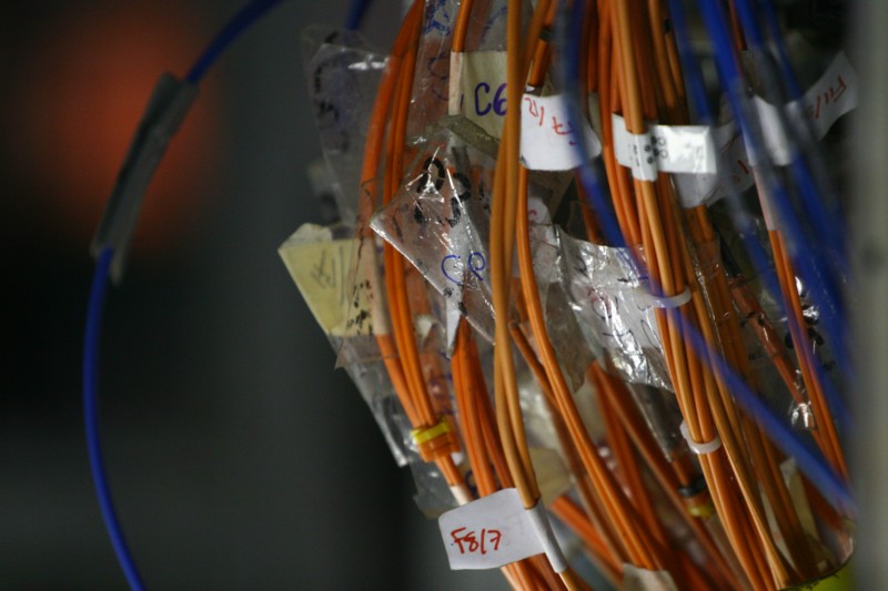 a bunch of orange wires and tags in plastic