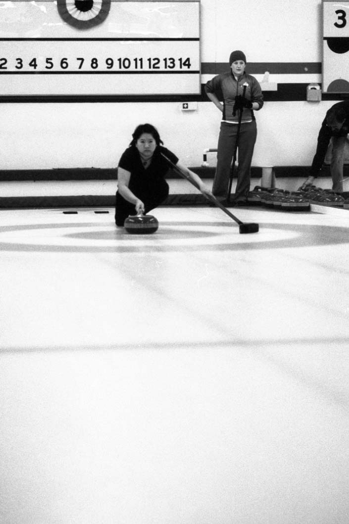 a lady sweeping a floor with a broom