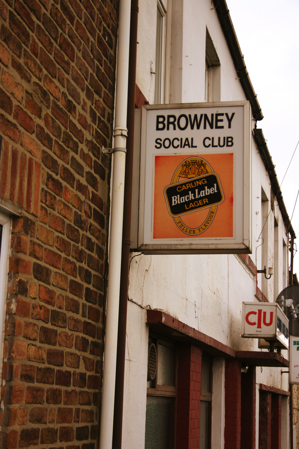 there is a sign that reads brownley social club on a side of a building