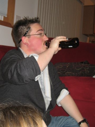 man drinking a beer in the living room