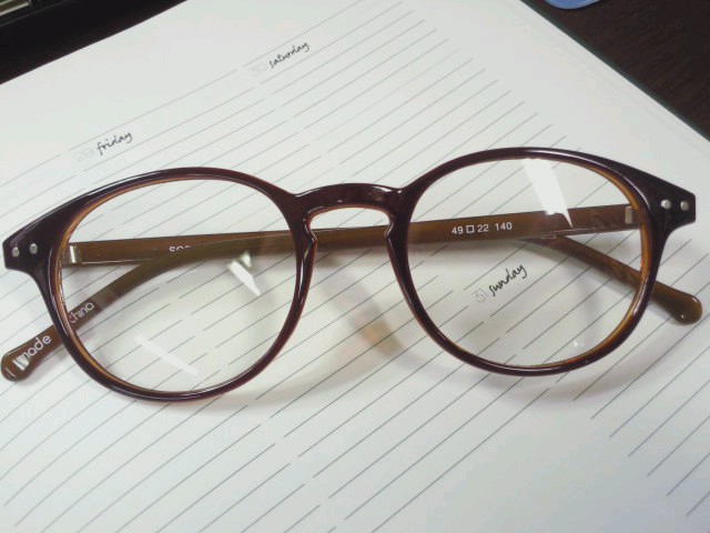 a pair of reading glasses are resting on a notebook