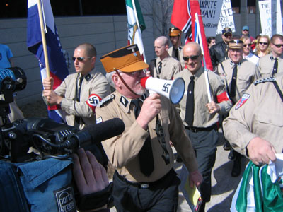 men walking with flags in their hands and wearing hats