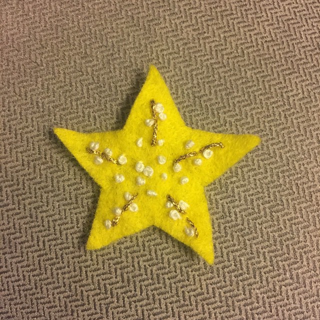 a yellow star is sitting on the ground