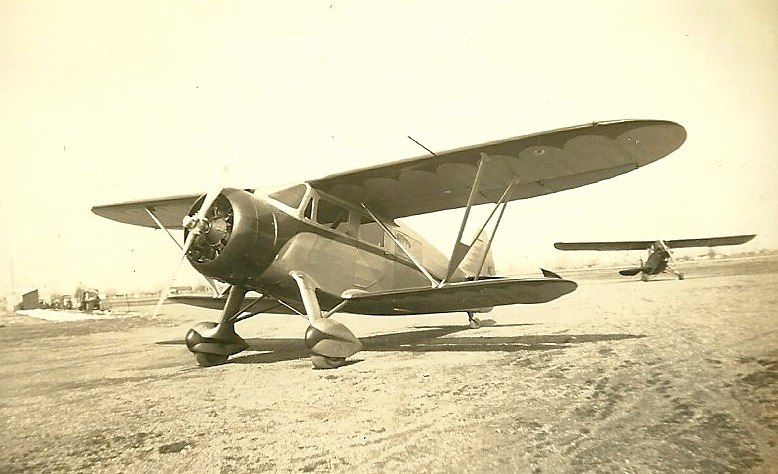 a biplane that is parked on a beach